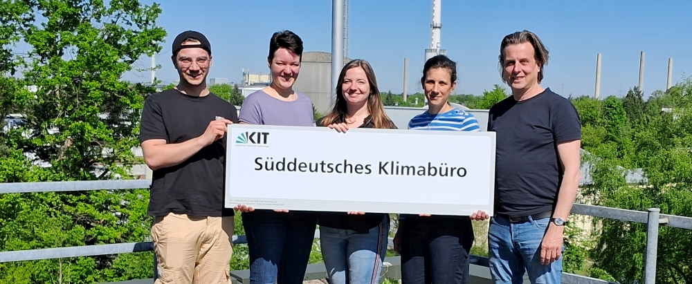 Menschen halten ein Schild mit der Aufschrift "Süddeutsches Klimabüro".